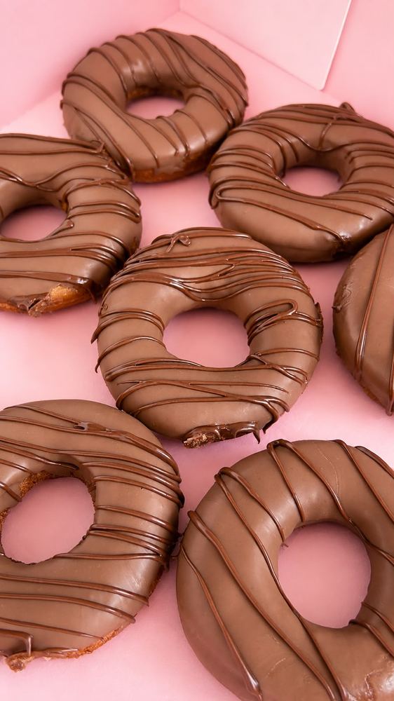 Chocolate dipped doughnuts with drizzle